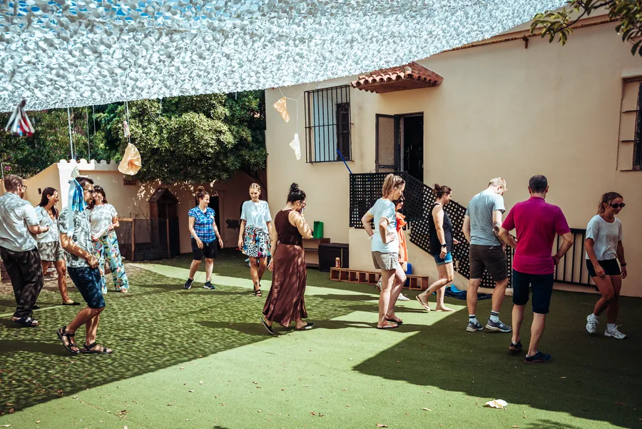 the cohort gathered on the lawn under the shade sails