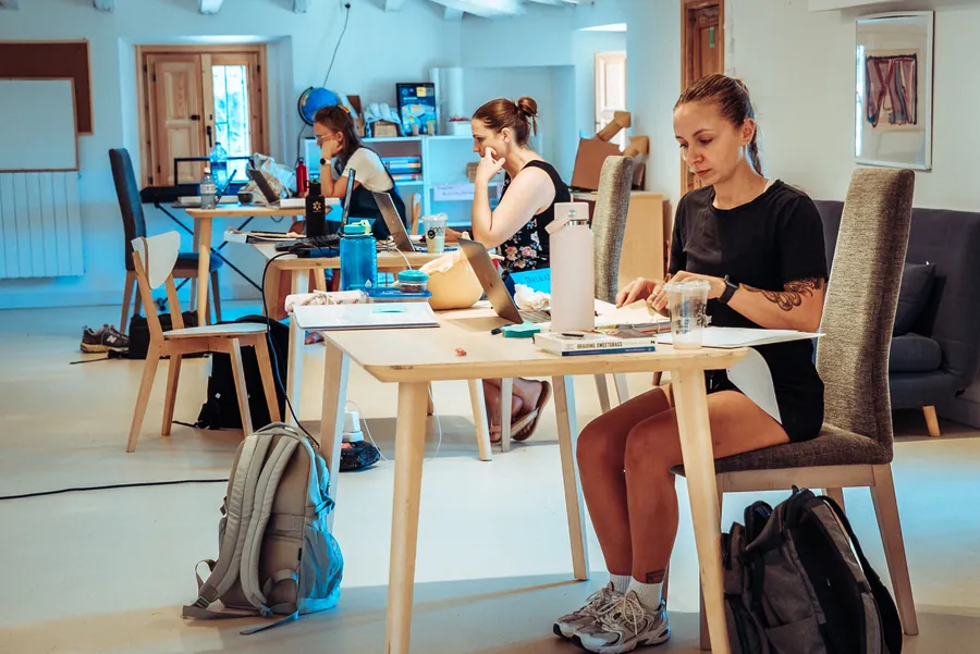 participants working at tables in the bright studio